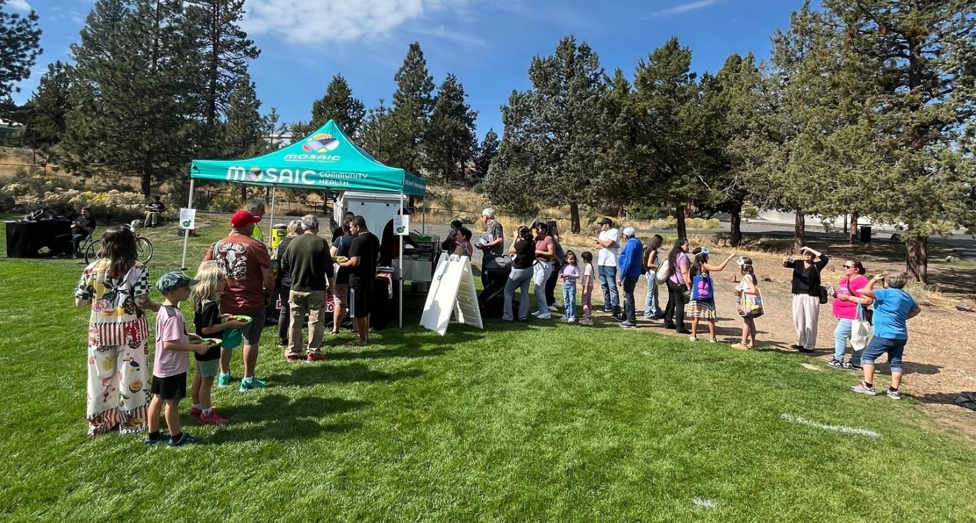 People in line at a Mosaic booth.