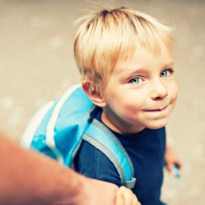 Young boy with backpack getting ready to go to school