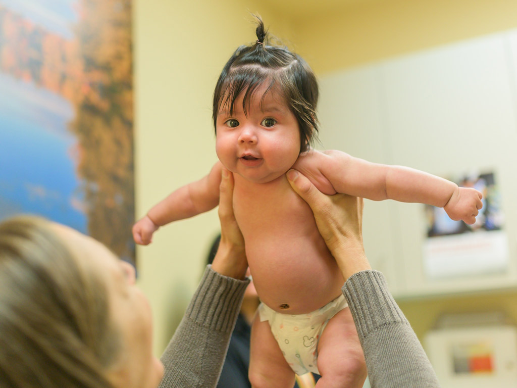 Mosaic pediatric provider holding baby 