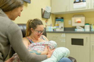 New mom with lactation specialist and newborn baby
