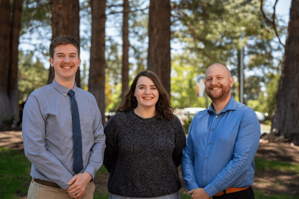Three Three Sisters Rural Track residents, Nathaniel Cheney, MD, Jolene Gremel, MD, and Patrick Roach, MD, standing outdoors in Central Oregon.