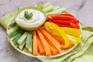 Greek yogurt dip with slices of vegetables